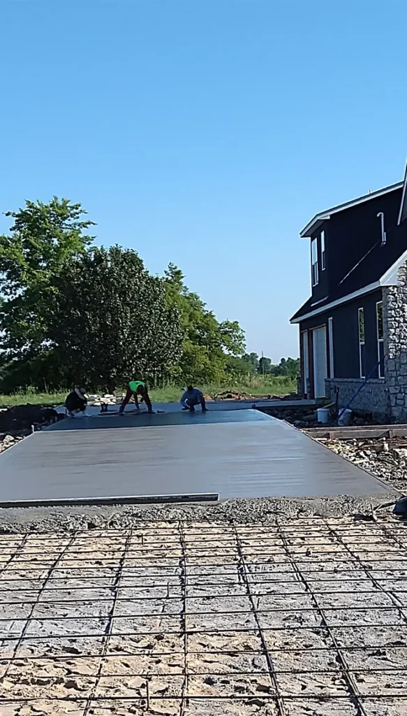 Large residential concrete slab installation in Tulsa showing rebar reinforcement and finishing work